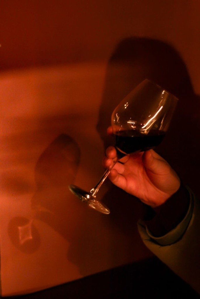 Hand holding red wine glass